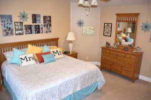 Bedroom with light carpet and ceiling fan