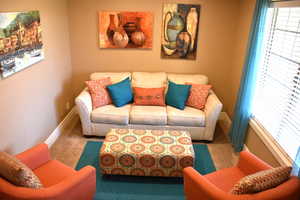 Living room featuring carpet flooring and baseboards