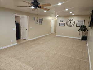 Spare room featuring light carpet, recessed lighting, ceiling fan, and a textured ceiling