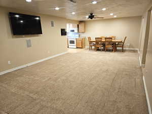 Dining area featuring recessed lighting, light carpet, a textured ceiling, and ceiling fan