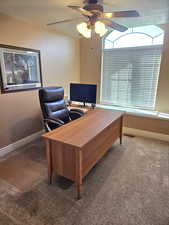 Office featuring a textured ceiling, carpet, and ceiling fan