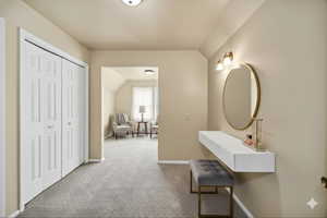 Virtually Staged sitting room area with carpet flooring and baseboards