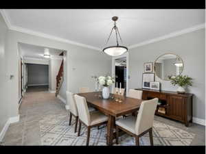 Virtually Staged Dining room featuring ornamental molding and stairway