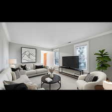 Virtually Staged Formal living room area featuring crown molding and baseboard heating