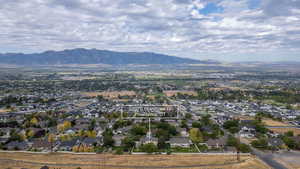 Aerial perspective of suburban area featuring a mountainous background