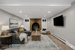 Virtually Staged Downstairs Living room with baseboard heating, recessed lighting, and wood finished floors