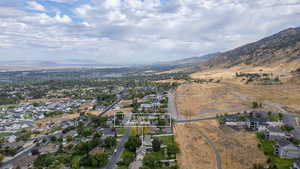 Aerial view of property's location featuring nearby suburban area and mountains