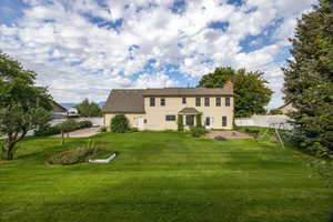 Back of house featuring a fenced backyard, a chimney, and a patio