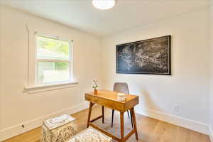 Office area with light wood-type flooring