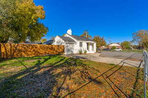 View of side of home featuring a chimney