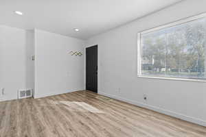 Unfurnished room with light wood finished floors and recessed lighting