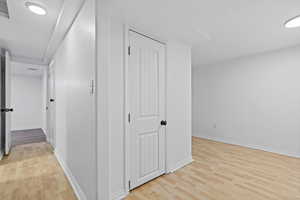 Hall featuring light wood-style floors