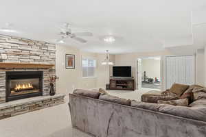 Living area with carpet flooring and a fireplace