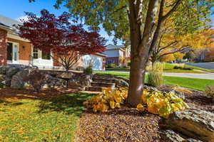 View of grassy yard featuring a garage