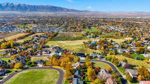 View of property location featuring a mountainous background, nearby suburban area, and abundant farmland