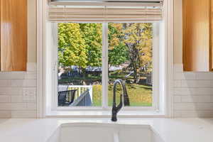 Kitchen view of tasteful backsplash and light stone countertops