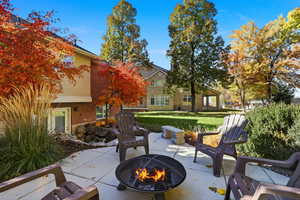 View of patio with an outdoor fire pit