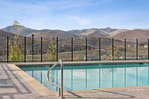 Community pool with a mountain view