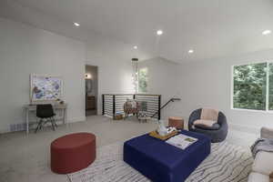 Living area featuring carpet floors and recessed lighting