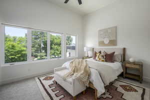 Carpeted bedroom featuring baseboards and a ceiling fan