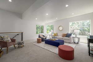 Carpeted living room featuring recessed lighting and plenty of natural light