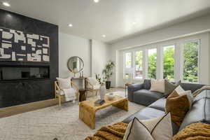 Living area featuring recessed lighting, wood finished floors, and a fireplace