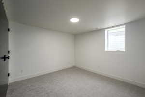 Unfurnished room with light carpet and baseboards