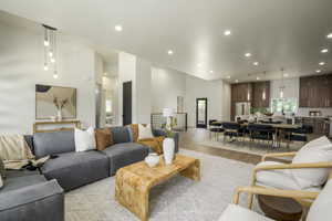 Living area with light wood-style floors and recessed lighting
