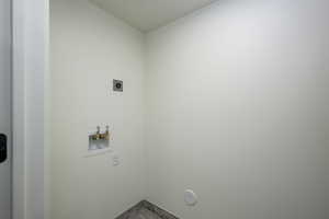 Washroom with hookup for a washing machine and hookup for an electric dryer