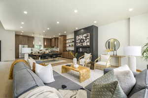 Living area with light wood finished floors and recessed lighting