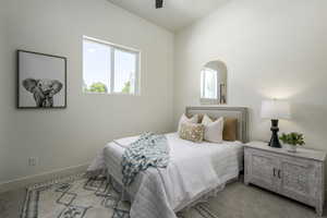 Bedroom featuring a ceiling fan and carpet