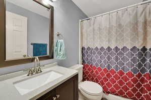 Bathroom with a shower with curtain and vanity