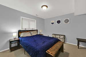 Bedroom featuring light colored carpet