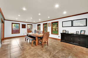 Dining space with recessed lighting, crown molding, and light tile patterned flooring