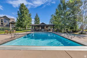 Community pool with a patio and a pergola