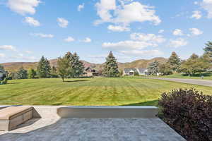 View of grassy yard with a mountain view