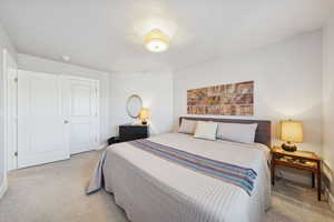 Bedroom featuring light carpet