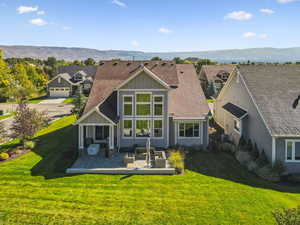 Rear view of property featuring a mountain view, board and batten siding, and a shingled roof