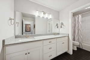 Bathroom with shower / bath combo with shower curtain, double vanity, and wood tiled floors