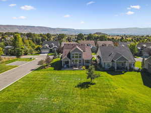 Aerial perspective of suburban area featuring a mountain backdrop