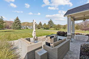 View of patio featuring an outdoor living space and a mountain view
