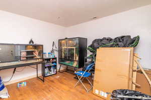 Miscellaneous room with wood finished floors