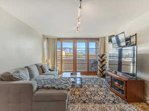 Living area featuring track lighting and floor to ceiling windows