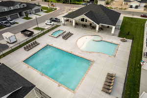 Community pool with a patio area and a hot tub