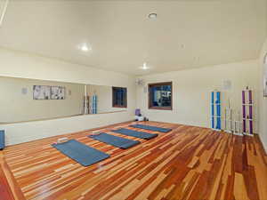 Workout room featuring recessed lighting and wood finished floors