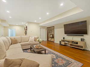 Living area with wood finished floors and recessed lighting
