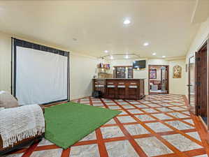 Interior space with inlaid floor details and recessed lighting
