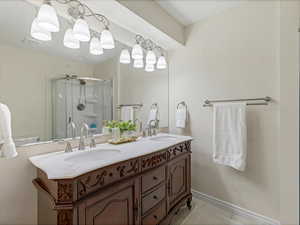 Bathroom featuring double vanity and a stall shower
