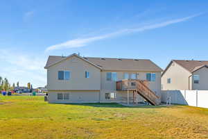 Back of property featuring stairs, a patio, a wooden deck, and roof with shingles