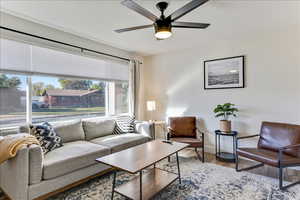 Living room featuring wood finished floors and ceiling fan